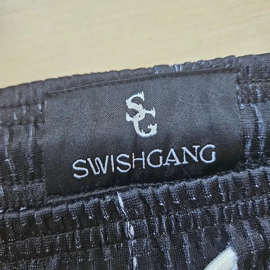 SwishGang woven brand tag detail on black star print basketball shorts waistband – SwishGang