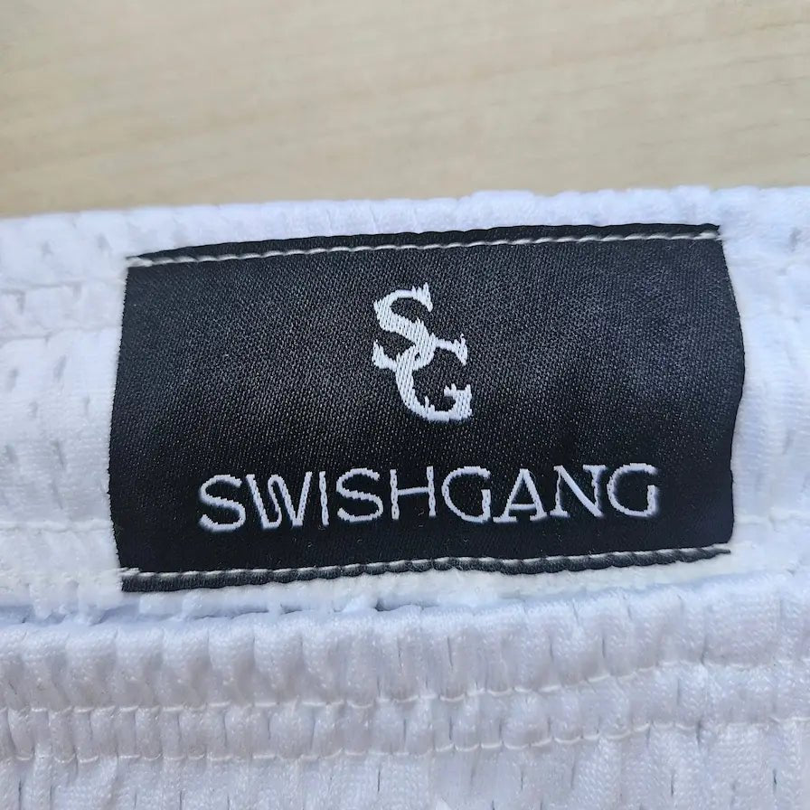 SwishGang woven brand tag detail on white star print basketball shorts waistband – SwishGang