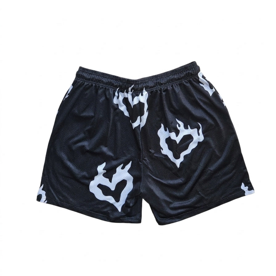 Studio product shot of the back of black basketball shorts featuring a white flaming heart pattern