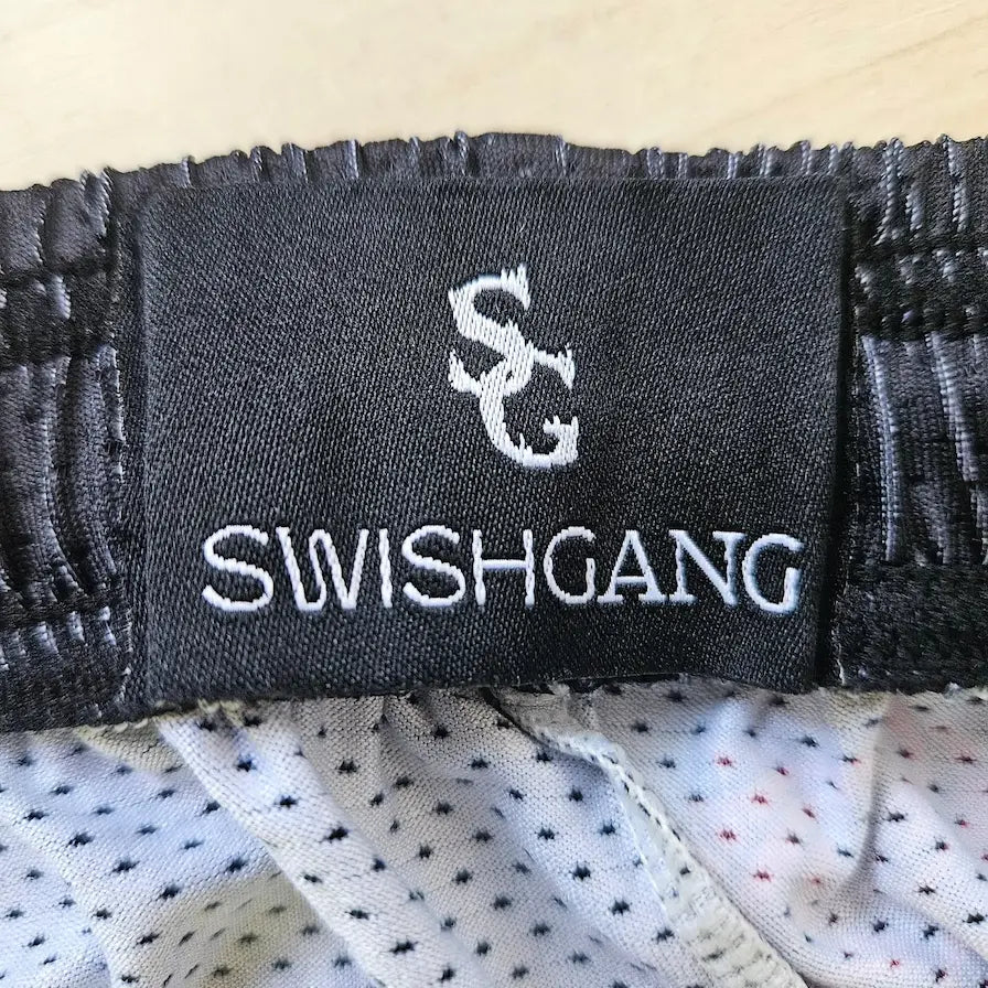 SwishGang woven brand tag detail on black basketball shorts waistband – SwishGang