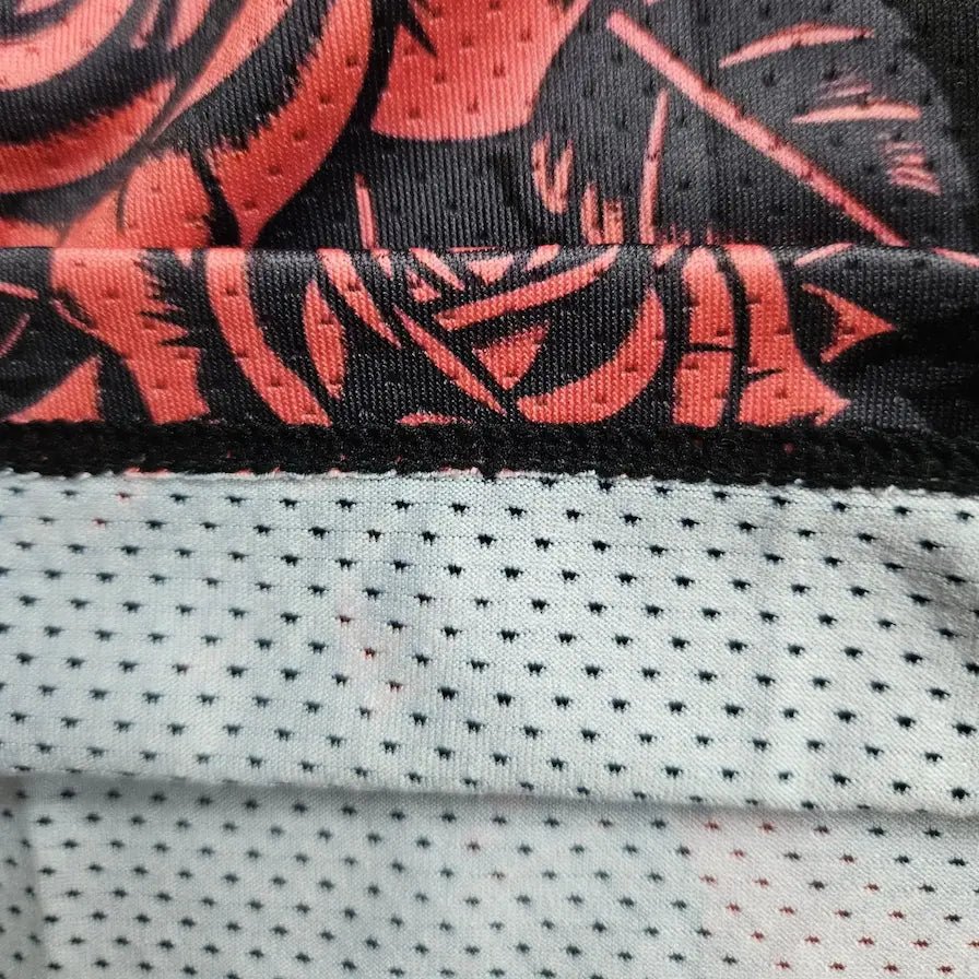 Single-layer mesh fabric detail showing rose print outer layer and breathable liner – SwishGang