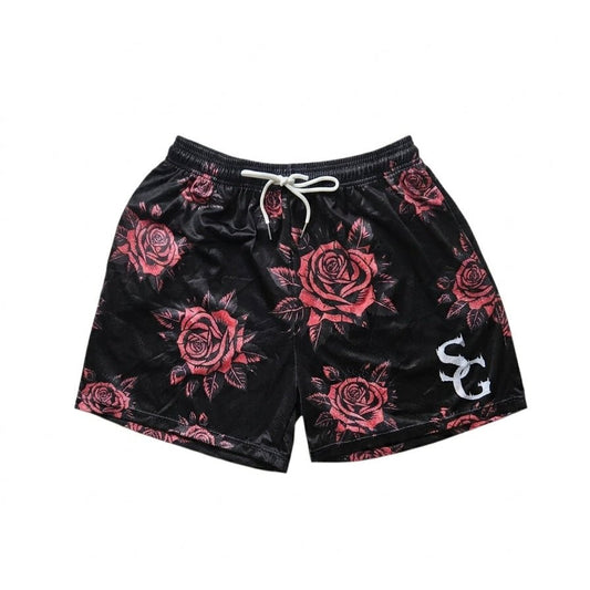 Studio product shot of black basketball shorts featuring a red rose pattern and a white logo on the left leg