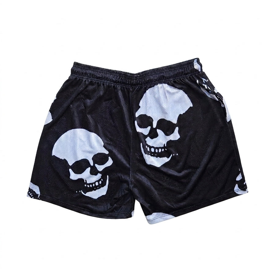 Studio product shot of the back of black basketball shorts featuring a white skull pattern