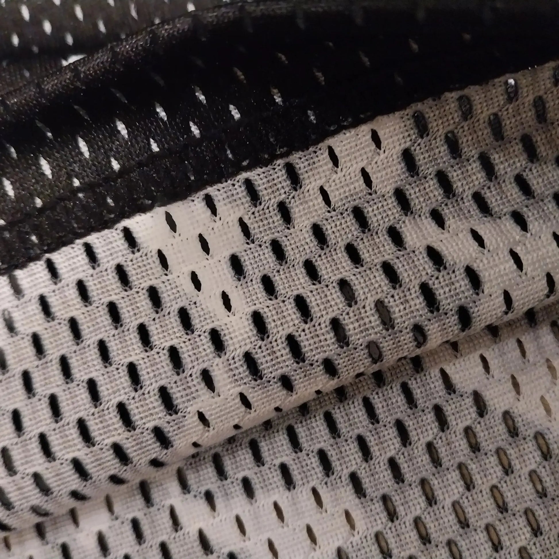 Close-up detail shot showcasing the breathable mesh fabric texture of the black basketball shorts